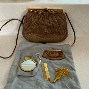 Brown snakeskin clutch with cabachon tiger eye closure, including accessories.